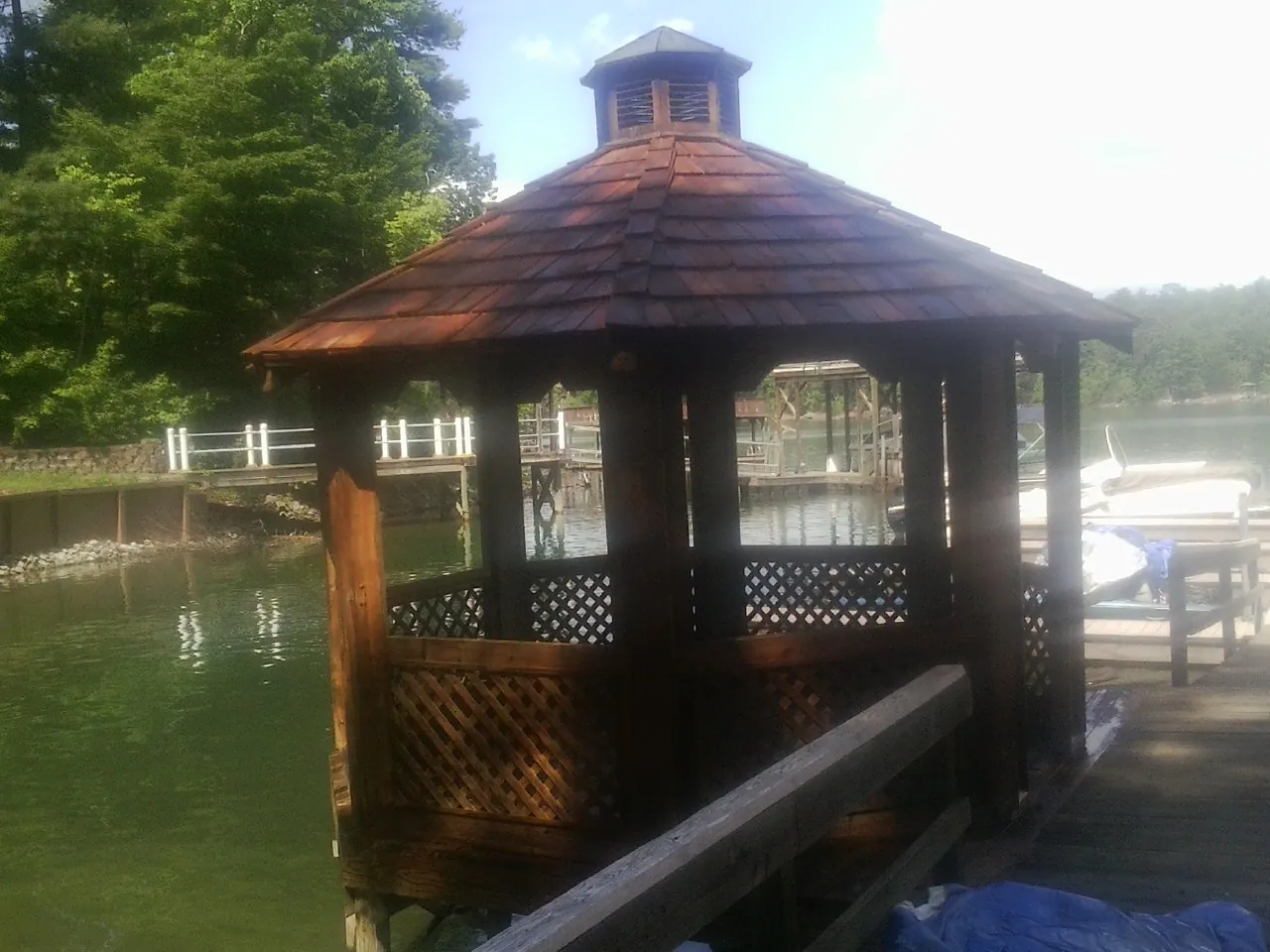 Cedar shake gazebo roof rebuilt on a lake dock in Creighton