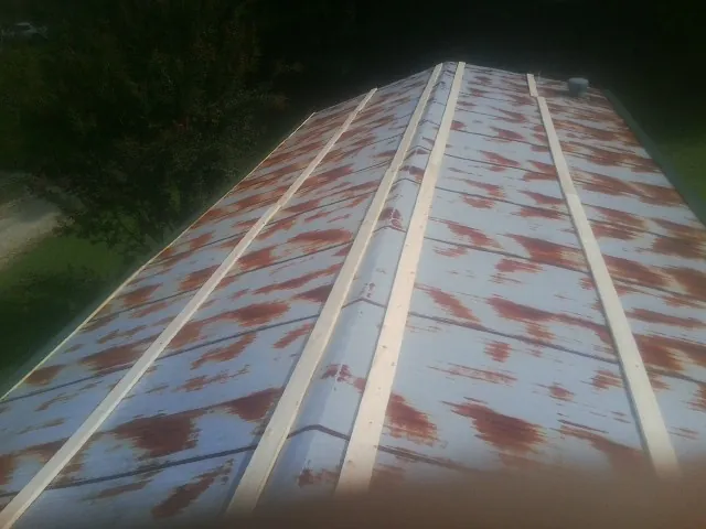Rusted metal roof panels with new wood purlins before replacement — Storm Damage Roof Repair in Creighton by Roofing Brothers